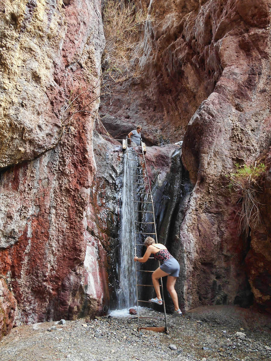 No way to climb the ladder without getting wet from the waterfalls, so we leave our dry clothes down below.