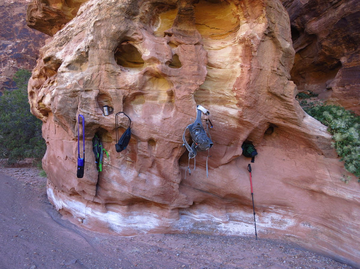 The opening to the small slot canyon is only 300 yards down, so some choose to leave their gear at "Locker Rock."