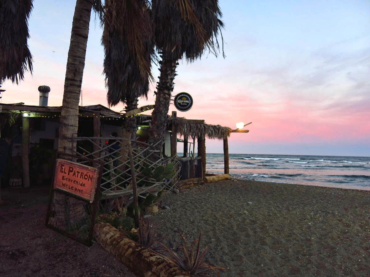 At the end of the walking path where the river meets the ocean is "El Patron" restaurant and beach bar.