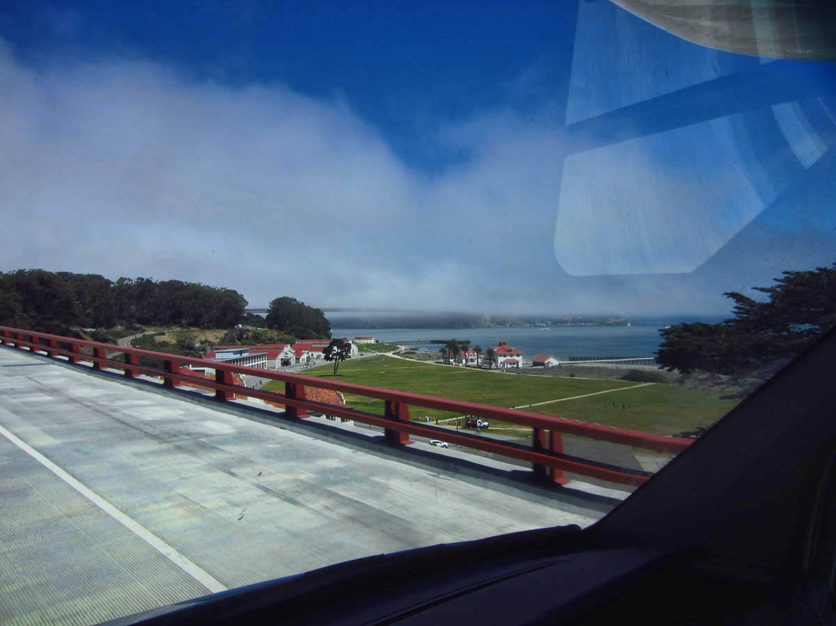 It's a beautiful blue sky day as I drive the Hwy 1 ramp to the bridge. But see that cloud on the horizon? That's the Golden Gate Bridge!
