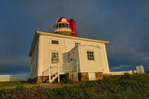 This style of wooden house around stone tower is similar to Cape Bonavista Lighthouse.